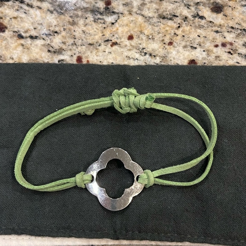 Costume bracelet - gold medallion center, green leather adjustable strap.